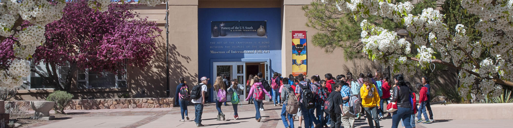 Students approach the front entrance of the Museum of International Folk Art.